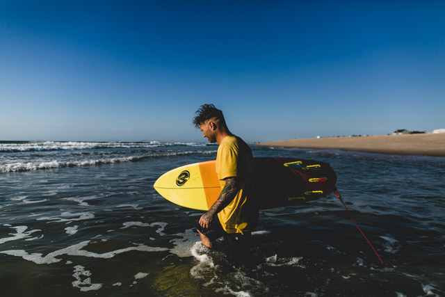 Jon Coen, content creator, riding crystal blue waves on Long Beach Island by Ryan Johnson