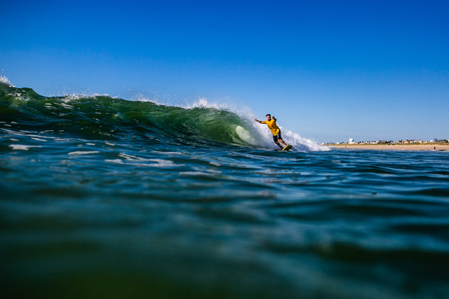 Jon Coen, content creator, riding crystal blue waves on Long Beach Island by Ryan Johnson